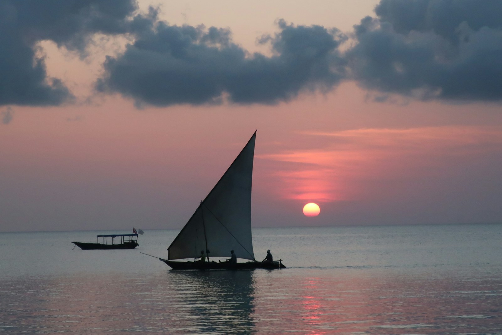 A traditional dhow sailing off Zanzibar at sunset over the Indian Ocean