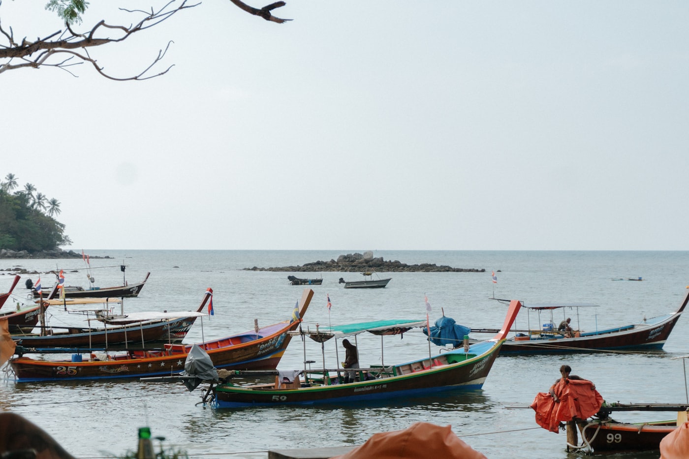 Traditional Thai longtail boats anchored at a turquoise sea