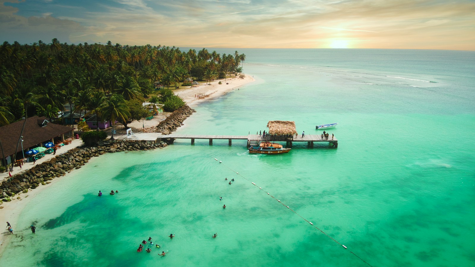 Aerial of the thatched jetty and turquoise water at Pigeon Point, Tobago