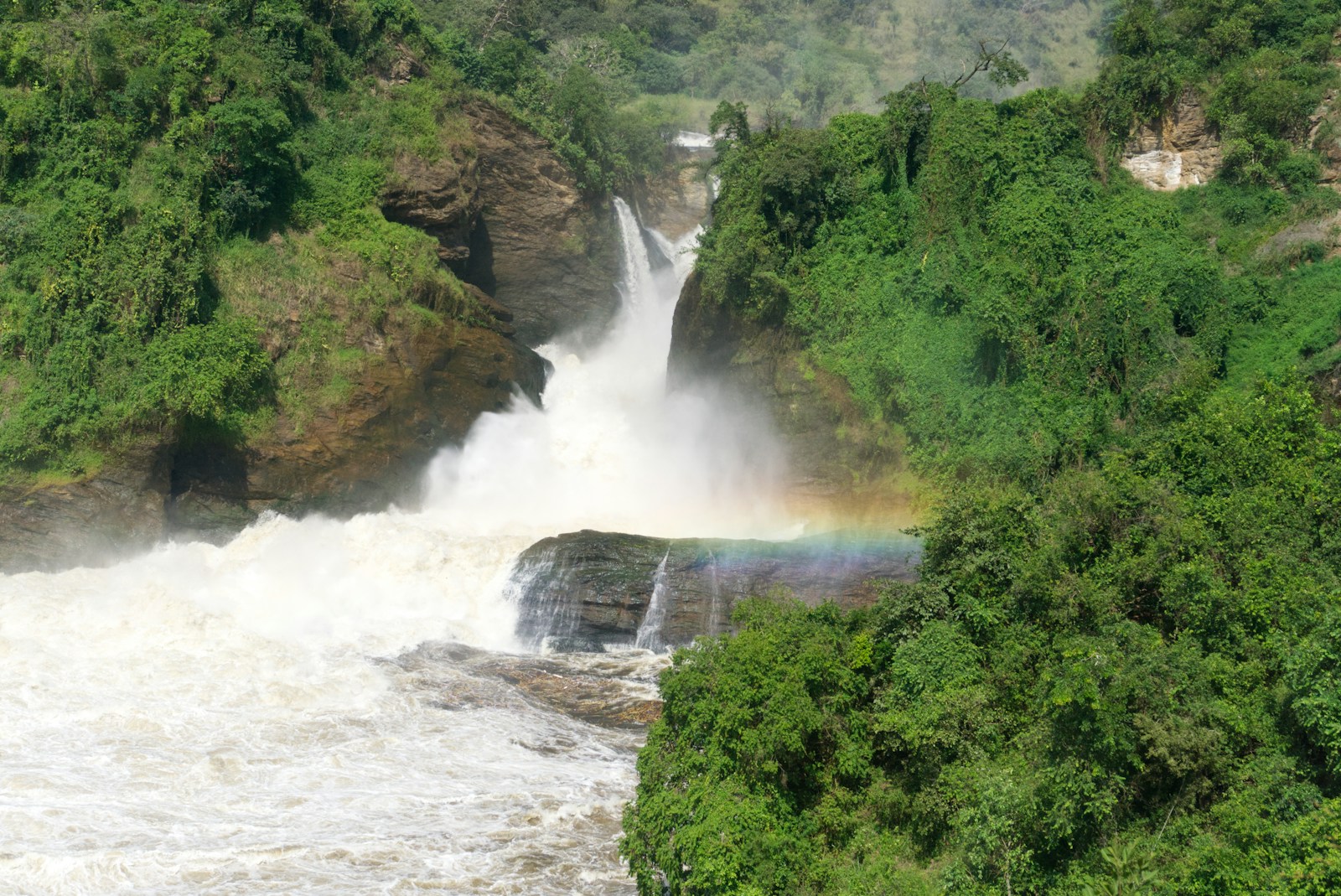 The Nile bursting through the gorge at Murchison Falls with a rainbow in the spray, Uganda