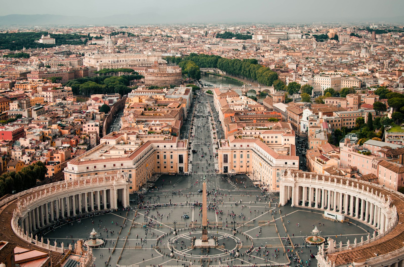 Aerial of St Peter's Square and Bernini's colonnade with Rome beyond, Vatican City