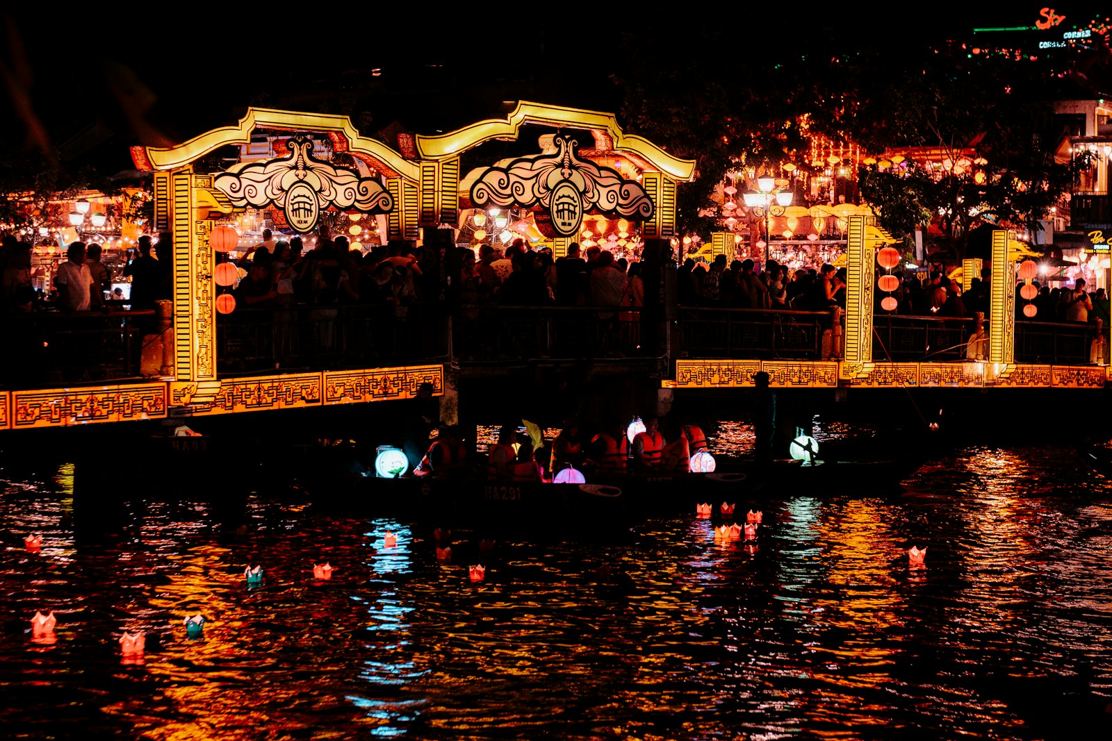 The lantern-lit bridge and floating candles of Hoi An at night